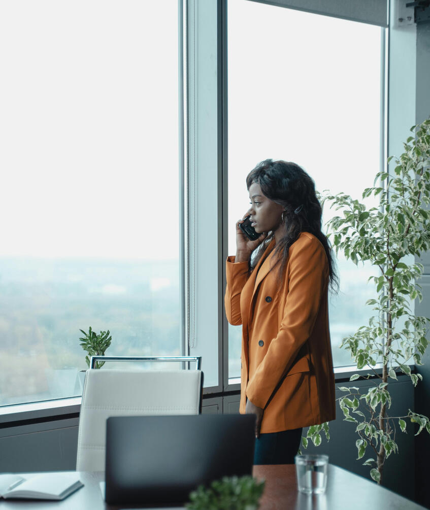 Women in red jacket talking on cell phone. thinking of life transition, change in direction.